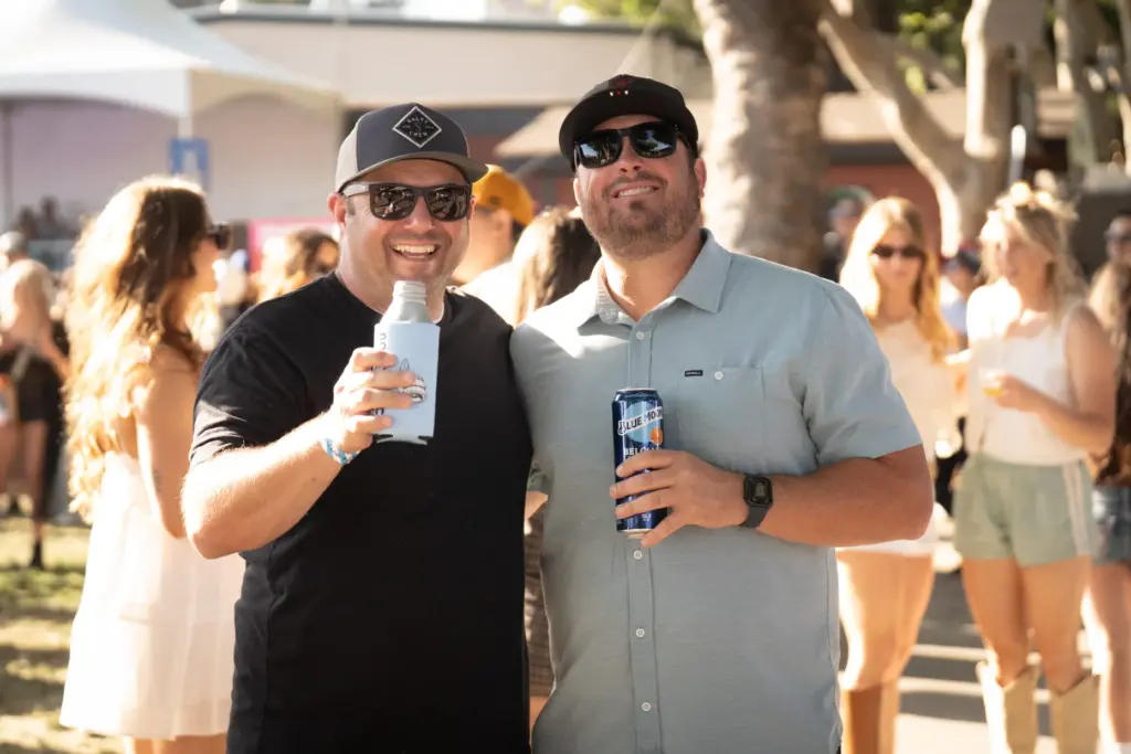 Two friends keep it casual with ball caps and shades...