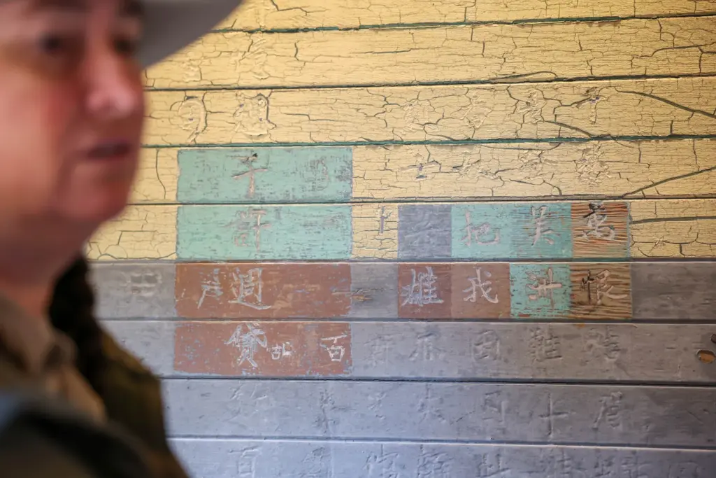 Angel Island State Park Interpreter Casey Dexter-Lee shows a Chinese...