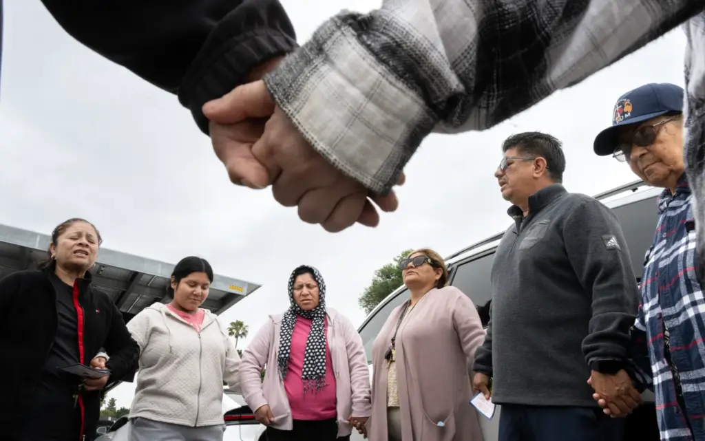 Members of Christ Breaks Chains church pray outside Savannah High...