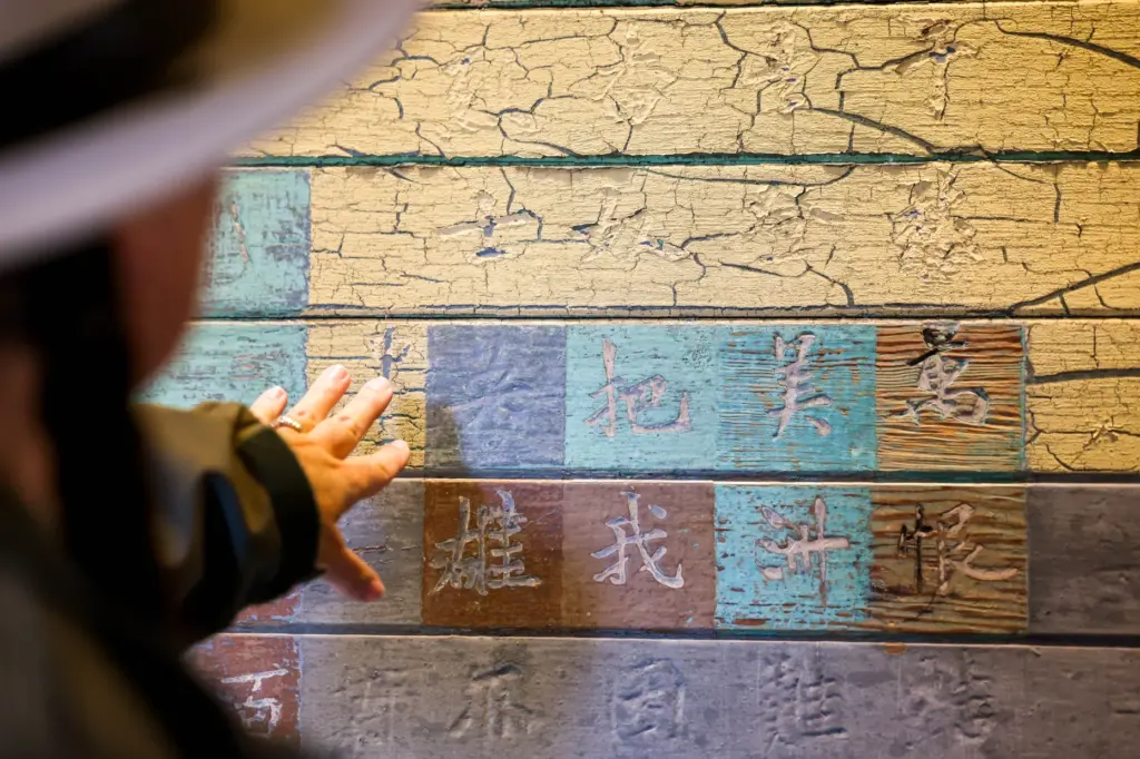 Angel Island State Park Interpreter Casey Dexter-Lee shows a Chinese...