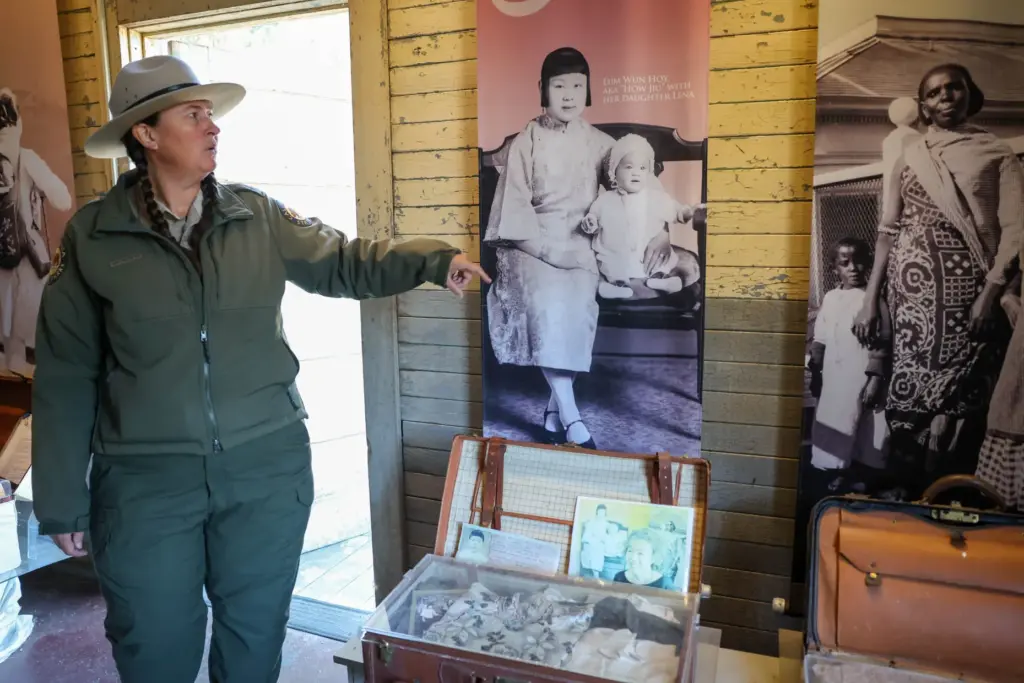 Angel Island State Park Interpreter Casey Dexter-Lee shows enlarged photos...