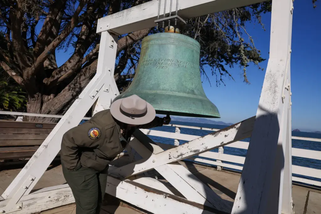 Angel Island State Park Interpreter Casey Dexter-Lee rings the original...