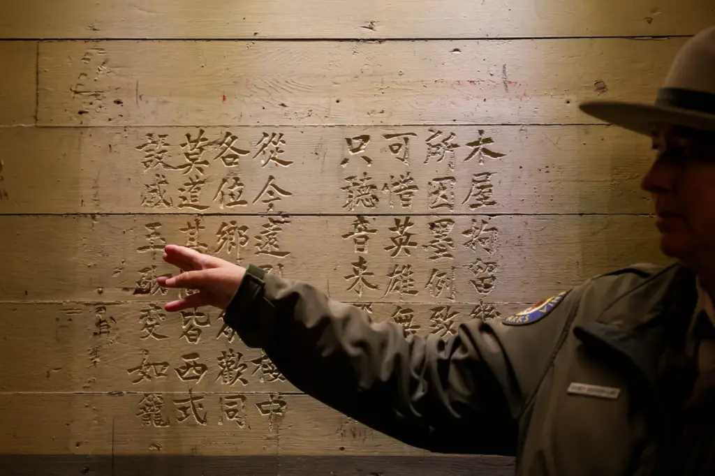 Angel Island State Park Interpreter Casey Dexter-Lee shows a Chinese...