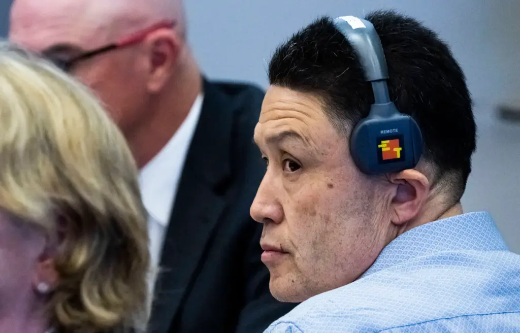 Kwong Chun Sit listens to opening statements in court in...