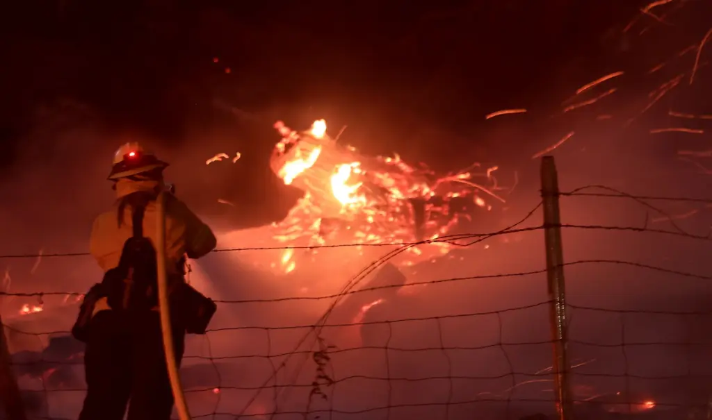 A Vacaville Fire Protection District firefighter douses a hot spot...