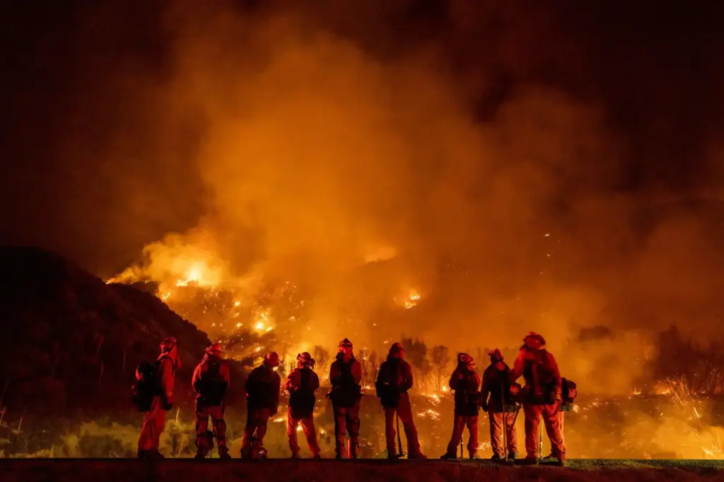A group of inmate firefighters watch as the El Dorado...