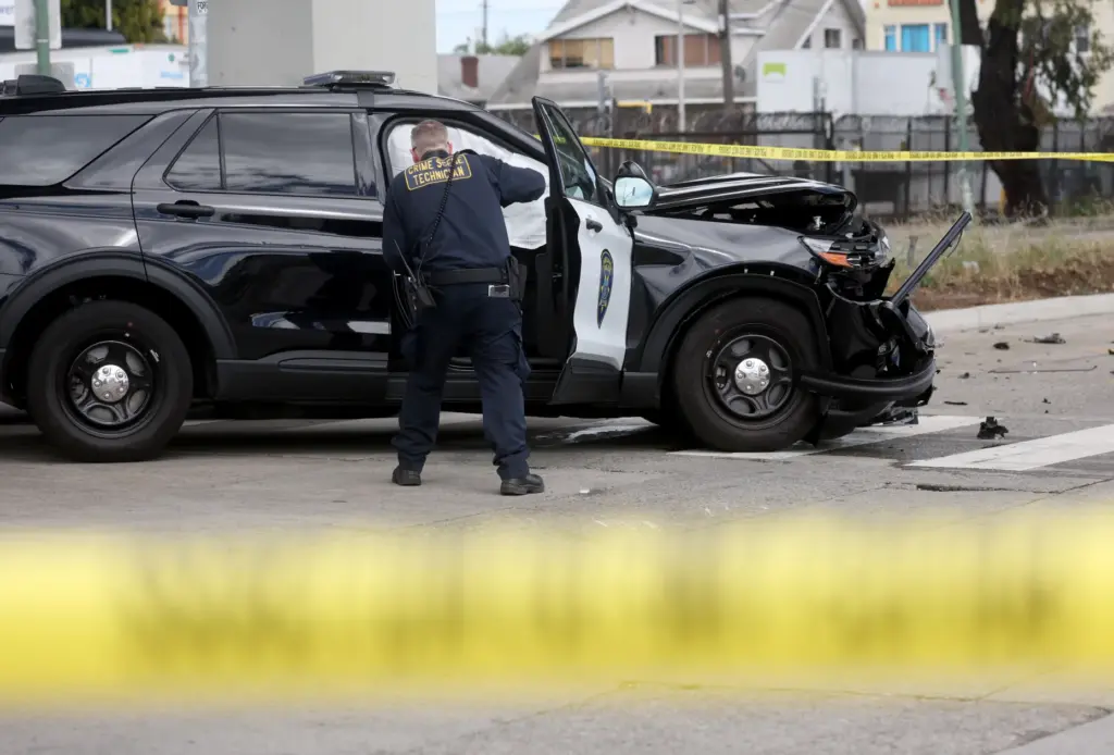 Oakland police investigate a double fatal crash involving a police...
