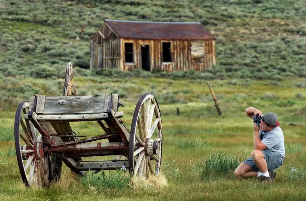 Jay Talbert photographs an old wagon at the Bodie State...