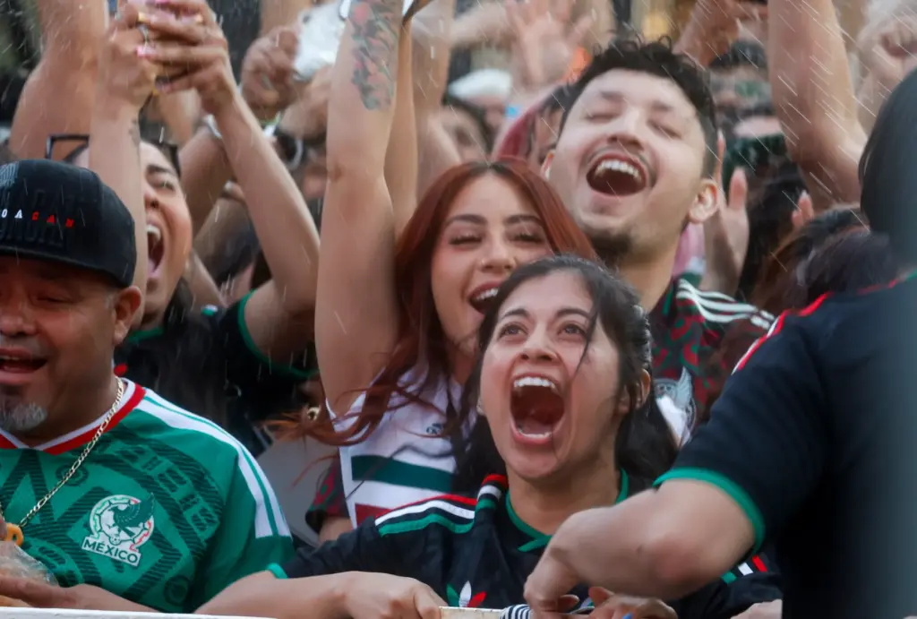 Mexico soccer fans celebrate a goal by Mexico, to make...