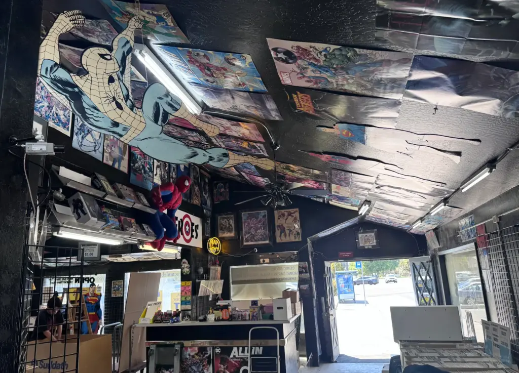 Posters decorate the ceiling of Heroes Comics in Campbell, which...