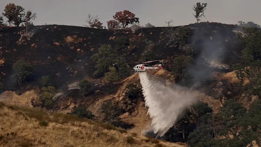 Cal Fireâs Howard Forest Helitack drops water on the Putah...