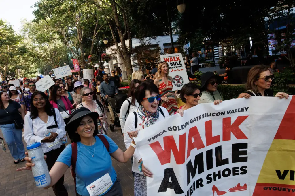 Participants march during the annual Walk a Mile in Their...