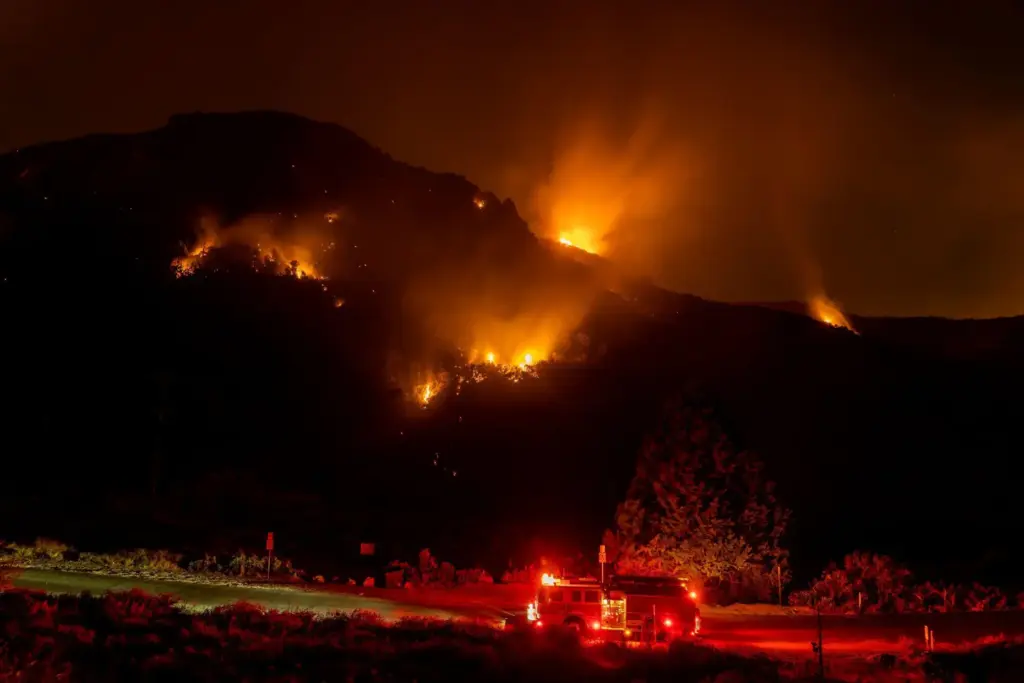 Firefighters monitor the El Dorado Fire as it burns a...