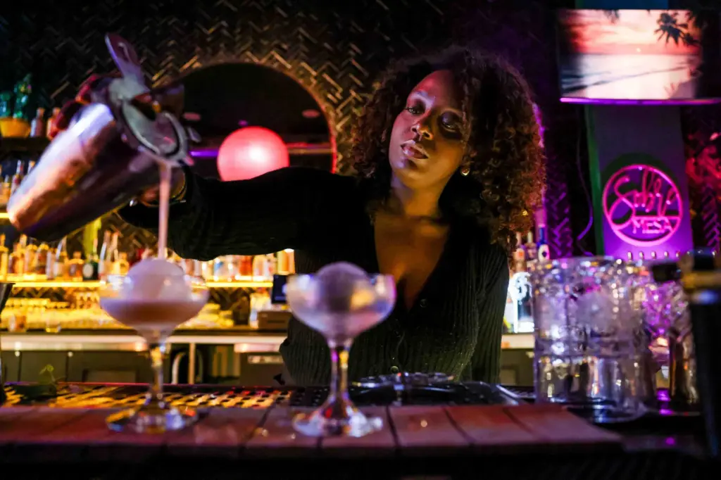 Bartender Anissa Kiyenba makes welcoming drinks named Nelsons, inspired by...