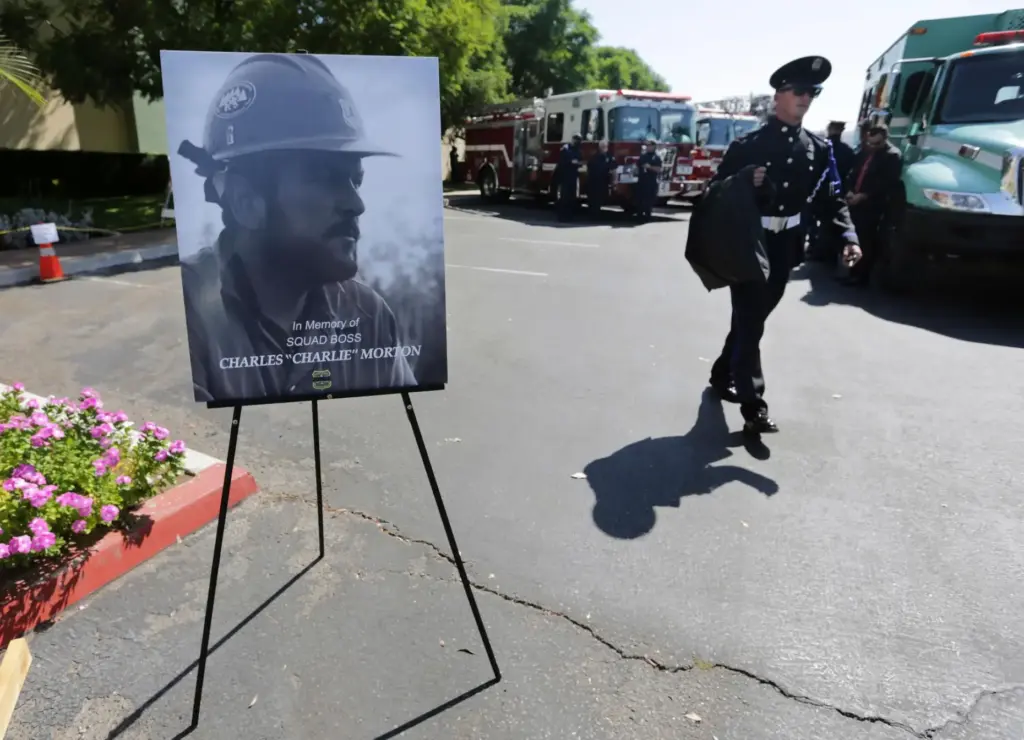Firefighters arrive to attend a memorial for Charles Morton, the...