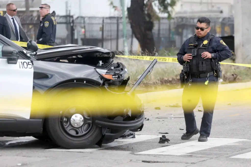 Oakland police investigate a double fatal crash involving a police...