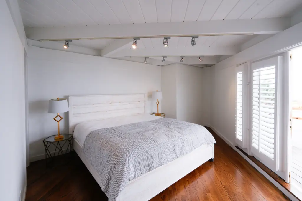 A bedroom in a La Jolla home designed by John...