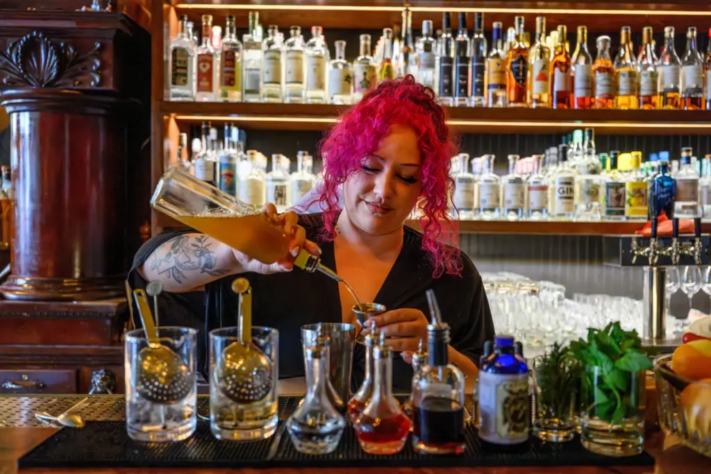 Bartender Nicki Ramos makes drinks at the Bull Valley Roadhouse...