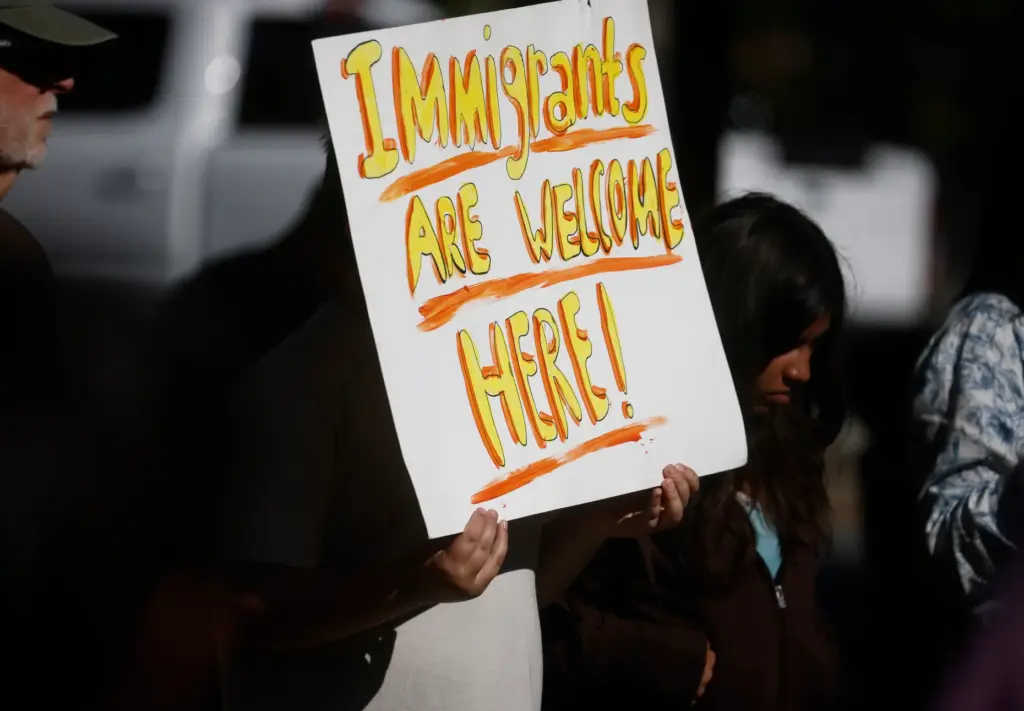 Community members attend a vigil called âFamilies in Homes Not...