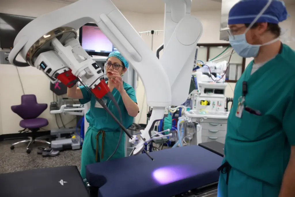 Dr. Rita Kwan-Feinberg, left, and robotics coordinator Max Bellmore, right,...