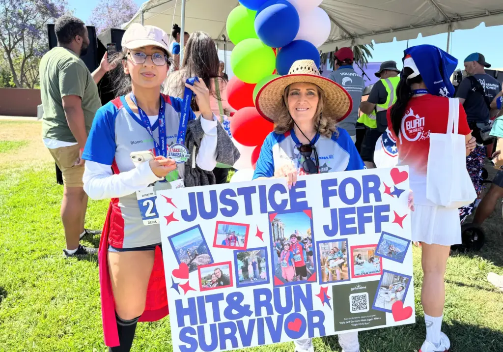 Laura Garmany, left, and Lori Garmany, right, hold up a...