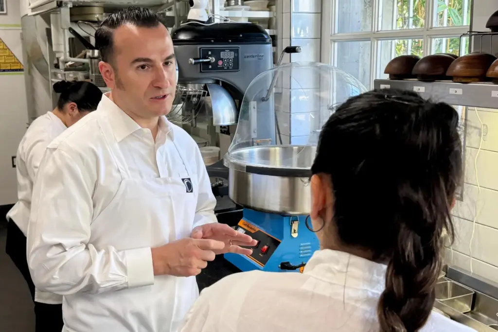 Chef Val Cantu, co-owner of Californios, speaks with a member...