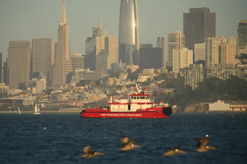 A San Francisco Fire Department vessel passes the city skyline...