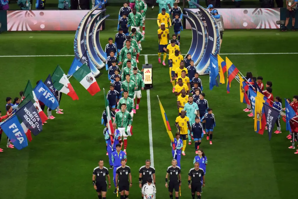 Players and referees enter the field before the World Cup...