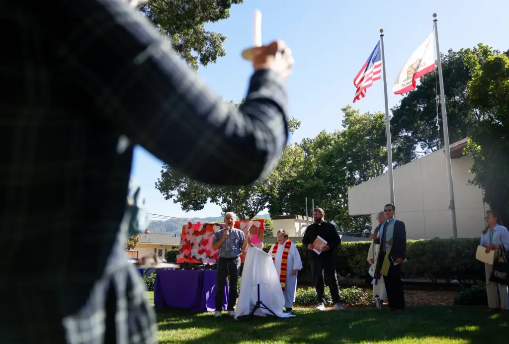 Community members attend a vigil called âFamilies in Homes Not...