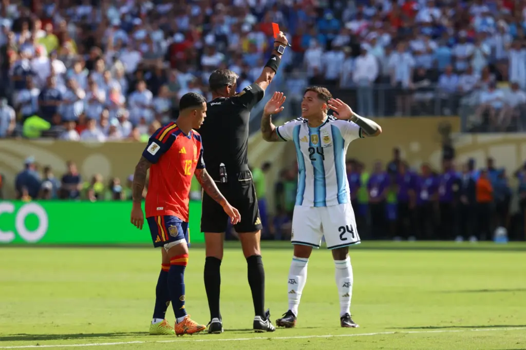 Referee Slavko Vincic, of Slovenia, gives a red card to...