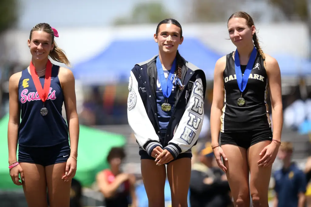 AB Hernandez of Jurupa Valley High School stands atop the...