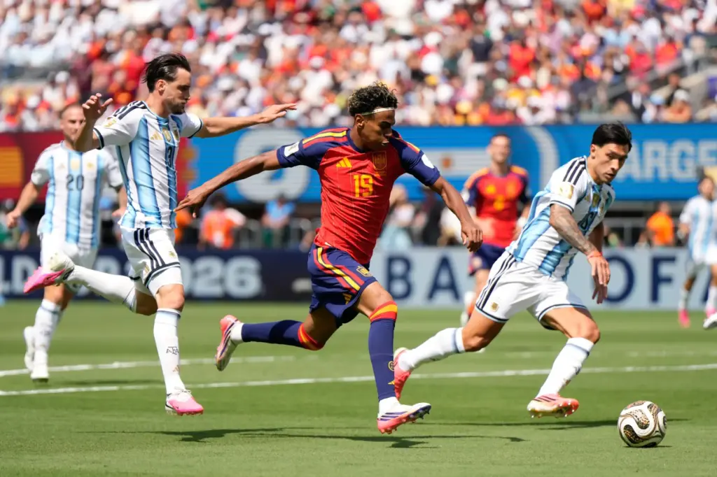 Spain’s Lamine Yamal runs with the ball during the World...