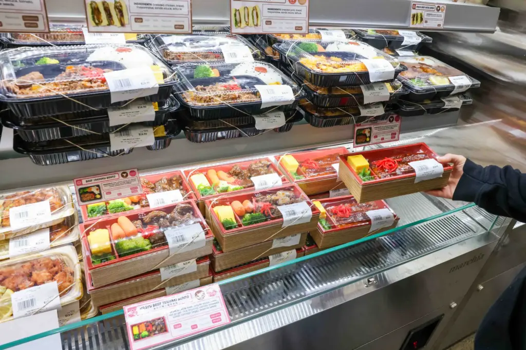 A customer serves herself meals ready to eat during the...