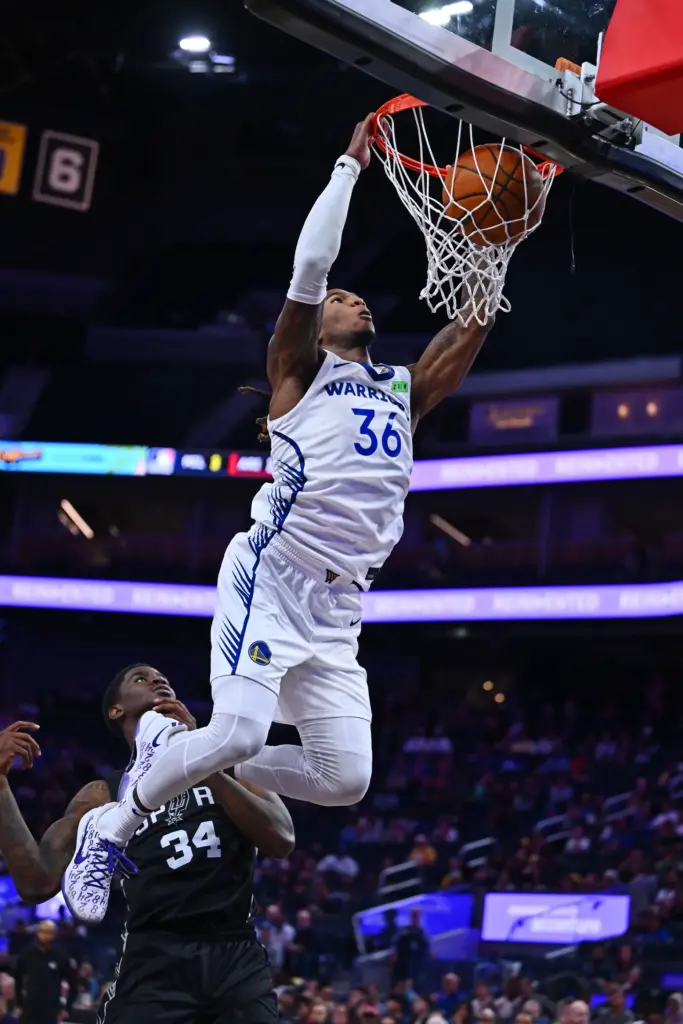 Golden State Warriorsâ Deivon Smith (36) dunks the ball past...