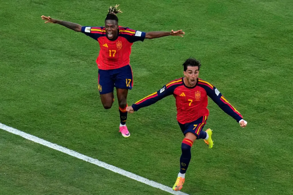 Spain’s Ferran Torres (7) celebrates after scoring the opening goal...