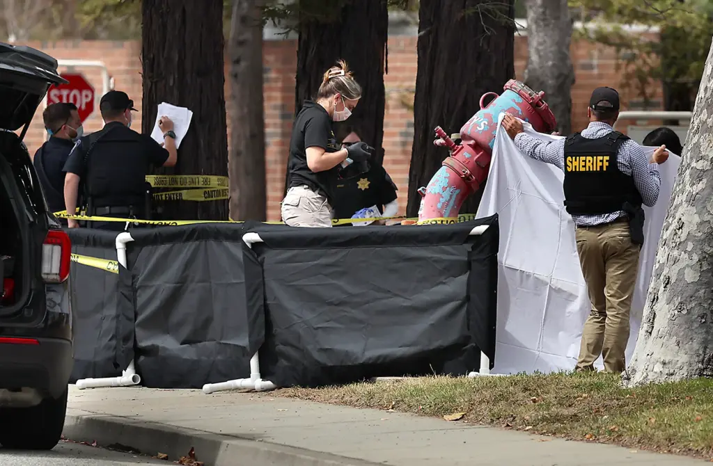 Incident screens surround the body of a 73-year-old woman killed...