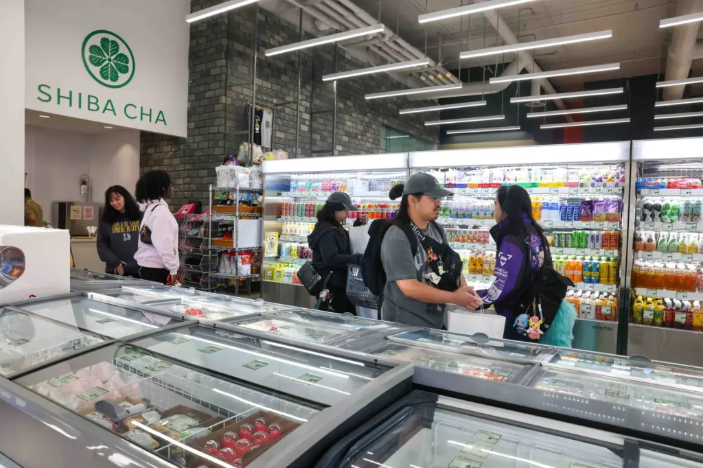 Customers explore Sakura Market during the grand opening of the...