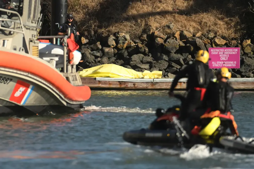 A body is covered with a tarp on a dock...