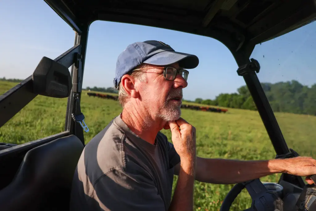 Cliff McConville, owner of All Grass Farms, drives his cart...