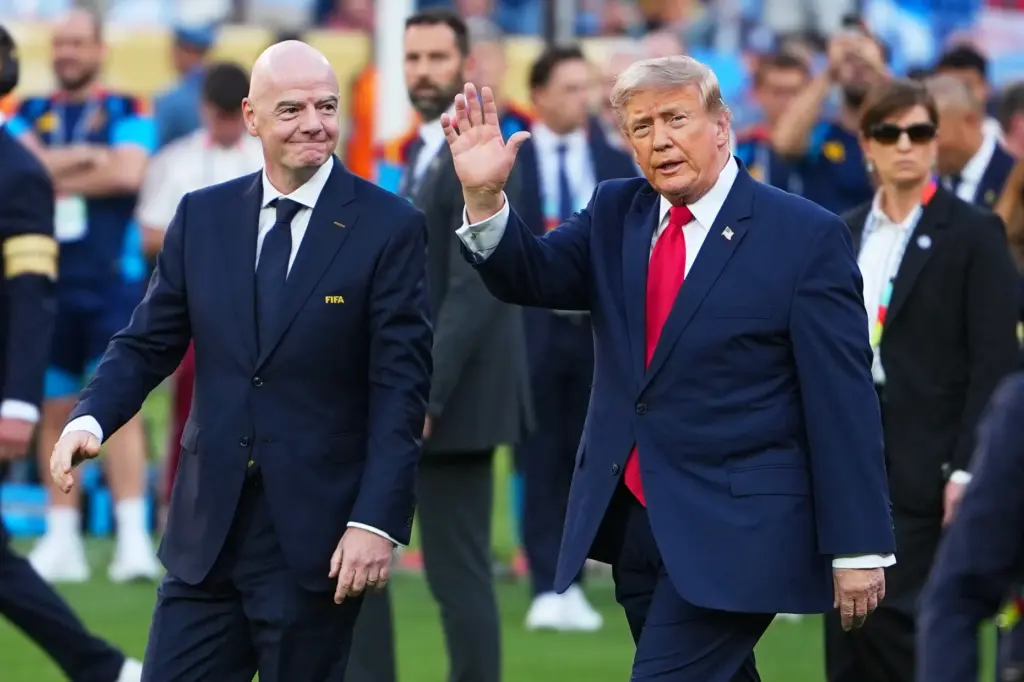 President Donald J. Trump walks with FIFA President Gianni Infantino...