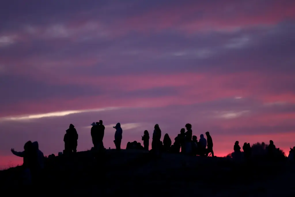 Local residents view illegal fireworks from a hillside as the...