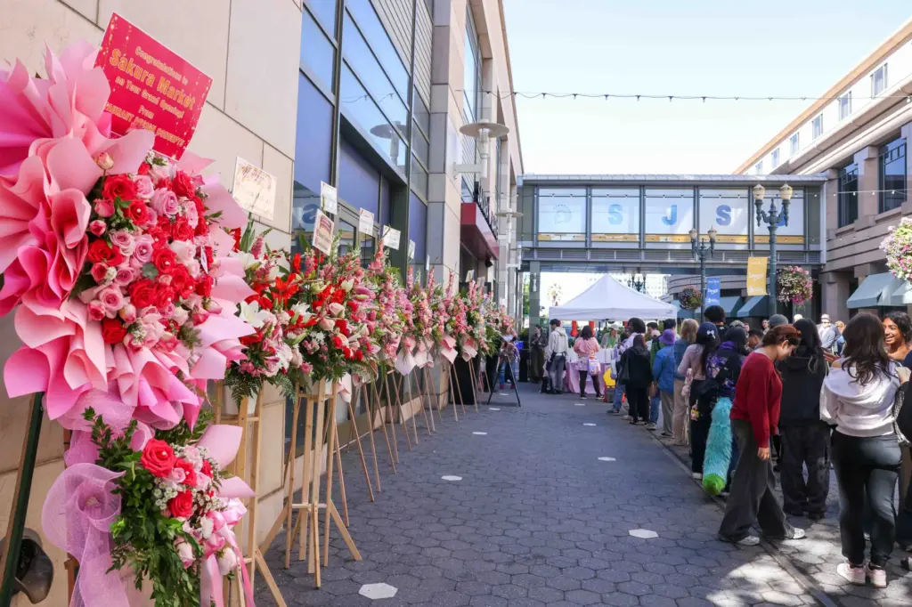 Wreaths of flowers sent by different people and businesses sit...