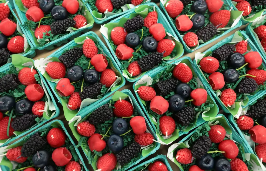 Mixed berry candles are packaged at Happy Organics' studio.
