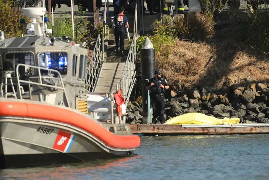 A body is covered with a tarp on a dock...