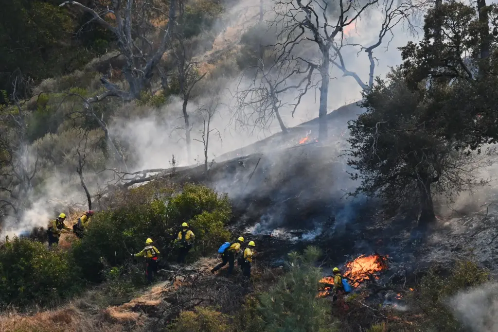 Fire crews work on extinguishing the Morgan Fire in unincorporated...