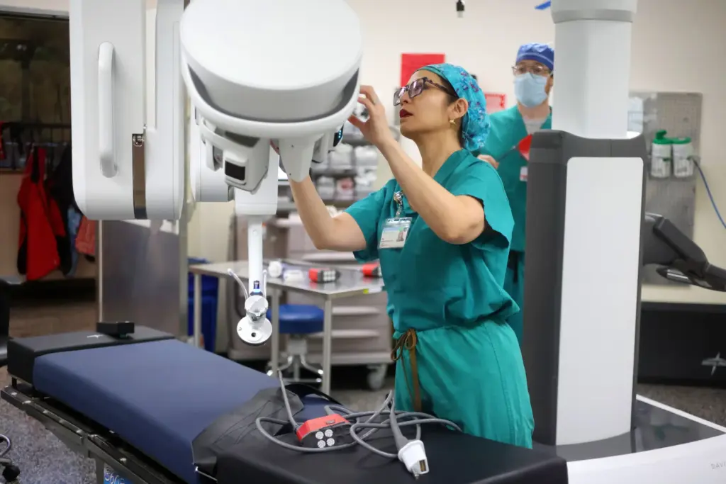 Dr. Rita Kwan-Feinberg with a da Vinci signal port surgical...