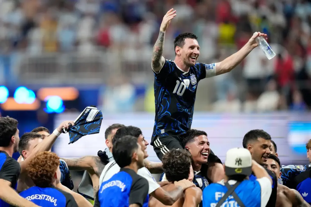 Argentina's Lionel Messi celebrates with his teammates at the end...