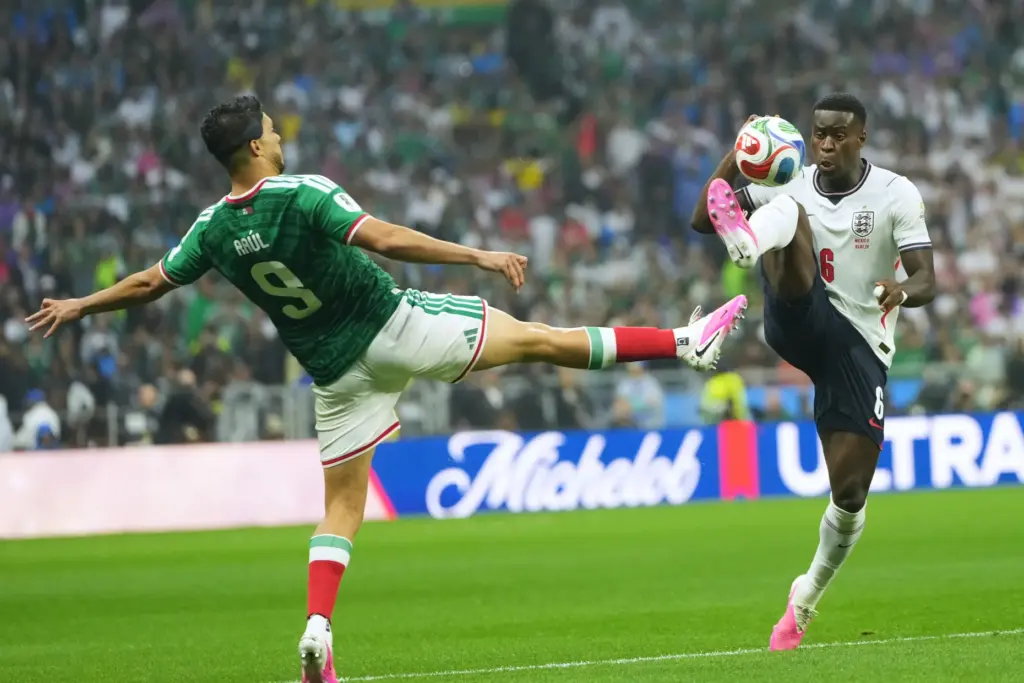 Mexico’s Raul Jimenez, left, and England’s Marc Guehi challenge for...