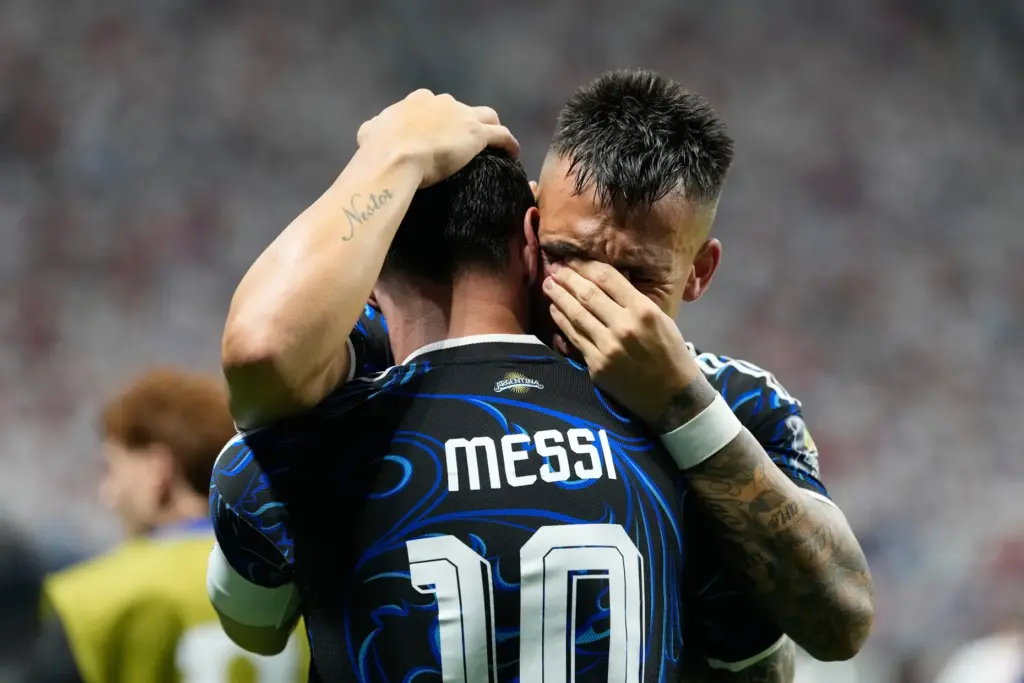 Argentina’s Lautaro Martinez hugs teammate Lionel Messi celebrating after scoring...