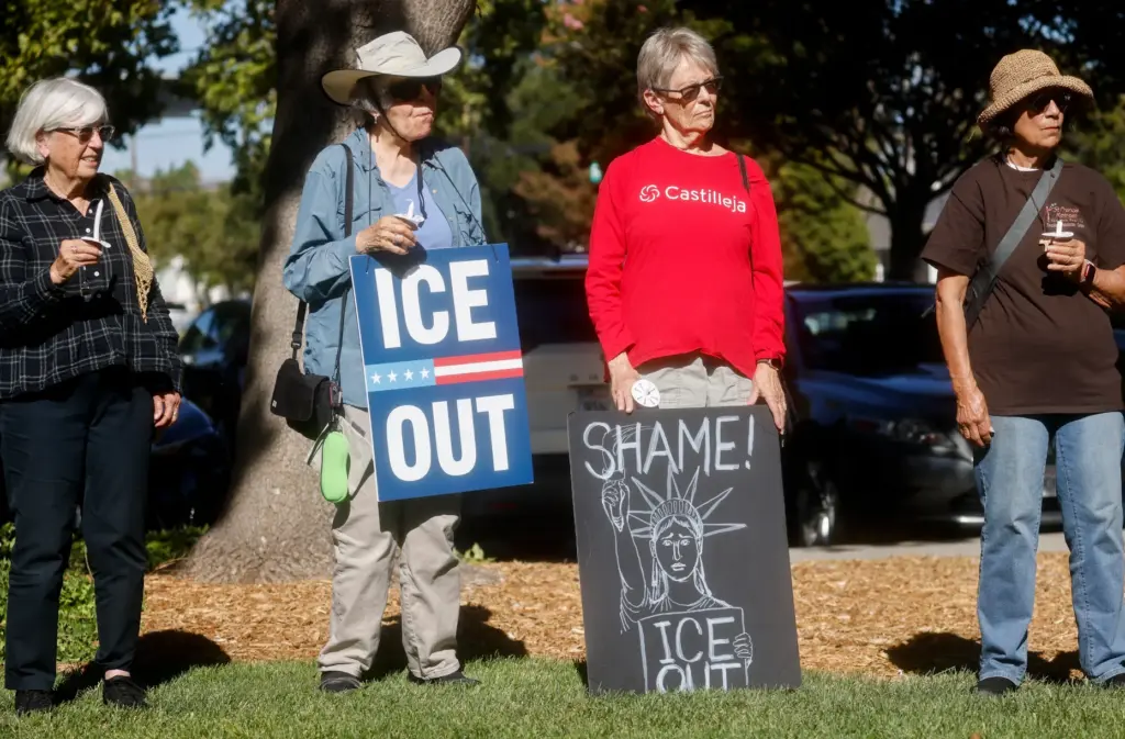 Community members, including Susan Betz, center left, and Linda Izquierdo,...